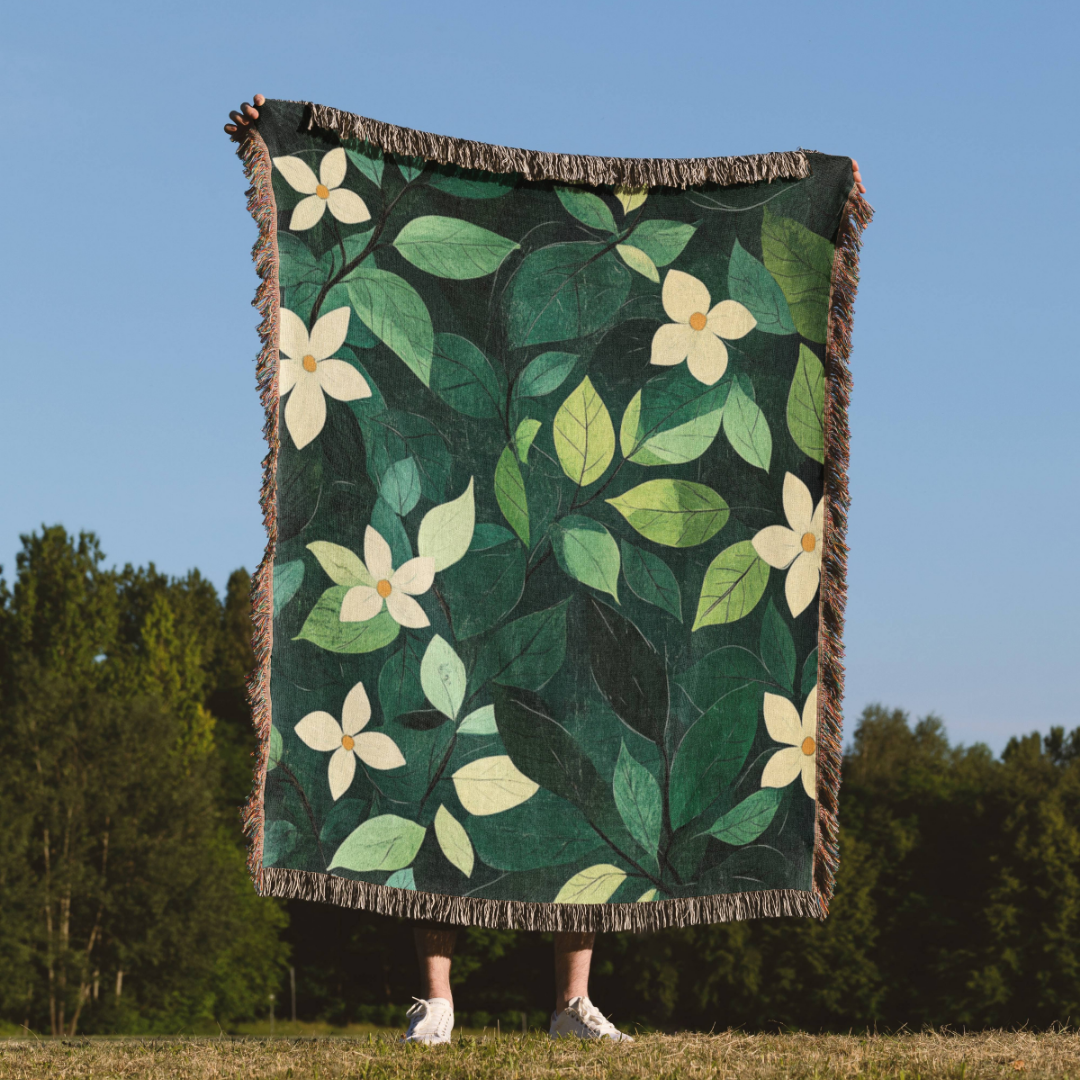 a person standing in a field holding a blanket with flowers on it