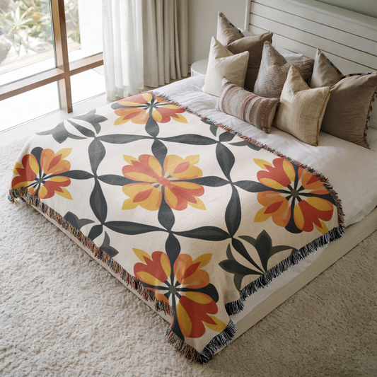 a bed with a blanket and pillows on top of it