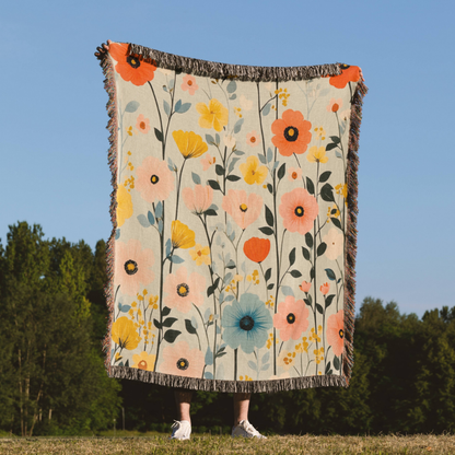 a woman standing in a field holding a blanket