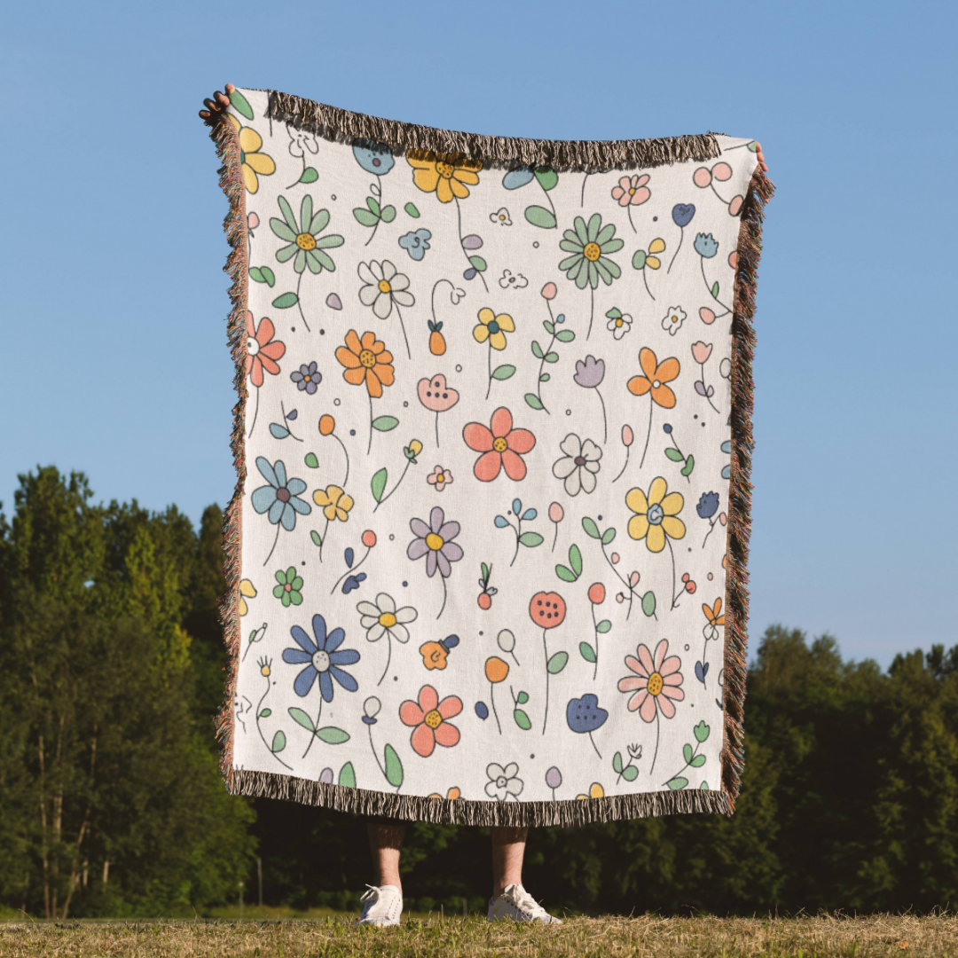 a person holding a blanket with flowers on it