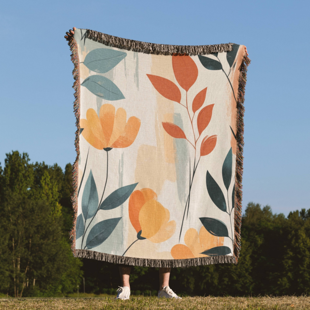 a woman standing in a field holding a blanket