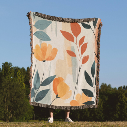 a woman standing in a field holding a blanket