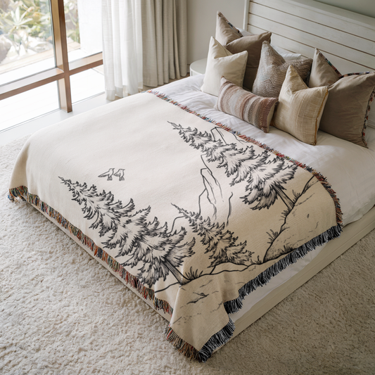 a bed with a white comforter and pillows on top of it