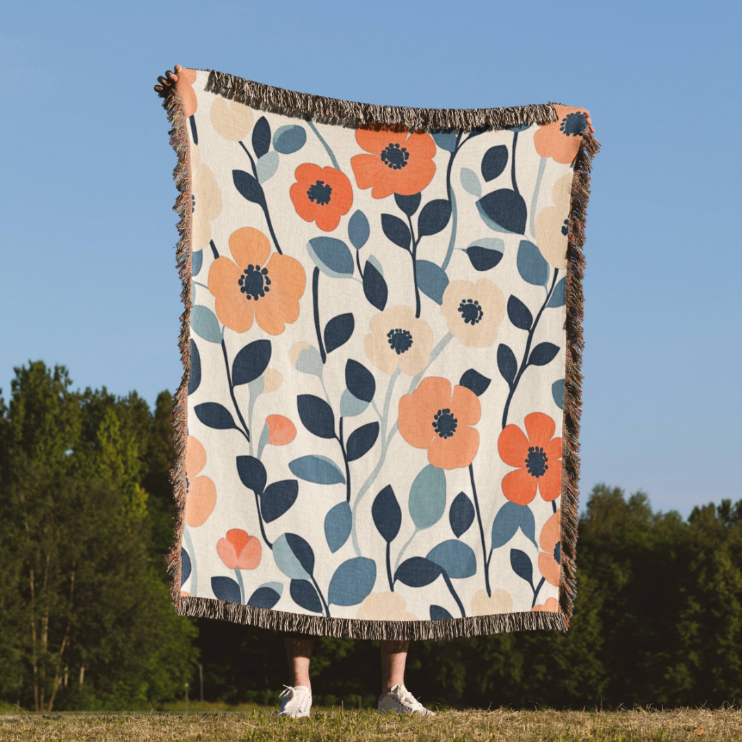 a woman standing in a field holding a blanket