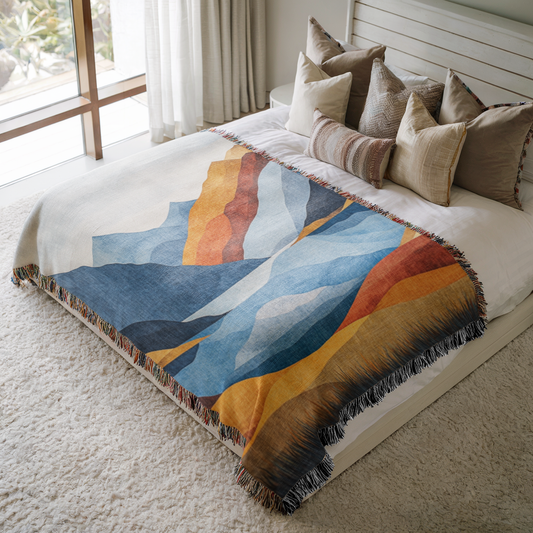 a bed with a blanket and pillows on top of it
