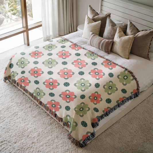 a bed with a blanket and pillows on top of it