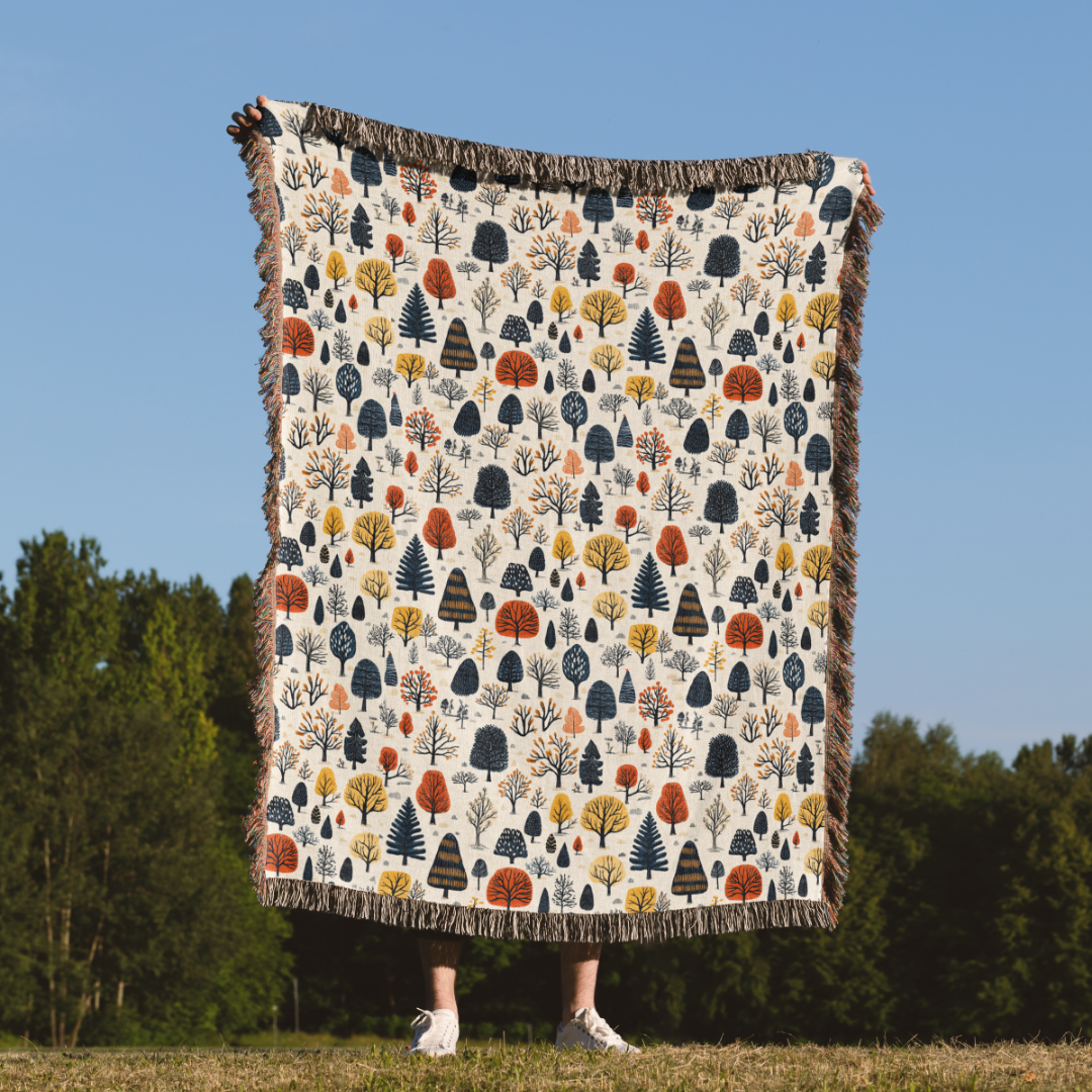 a person standing under a blanket with trees on it