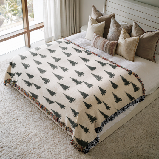a bed with a blanket and pillows on top of it