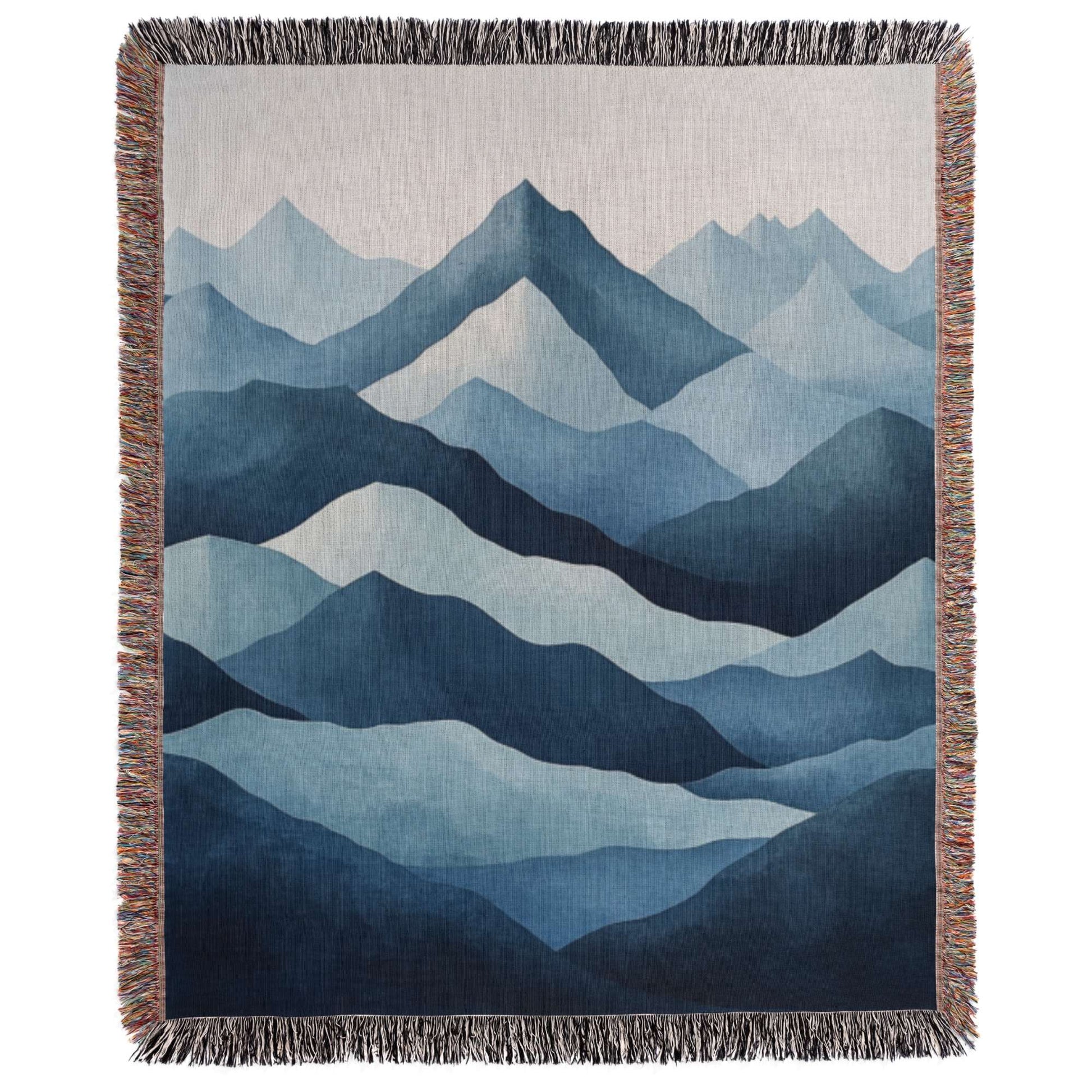 a blue and white tapestry with mountains in the background