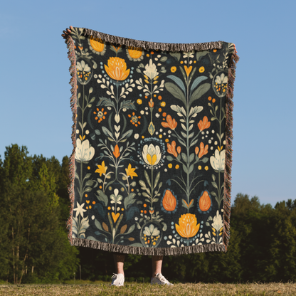 a woman standing in a field holding a blanket