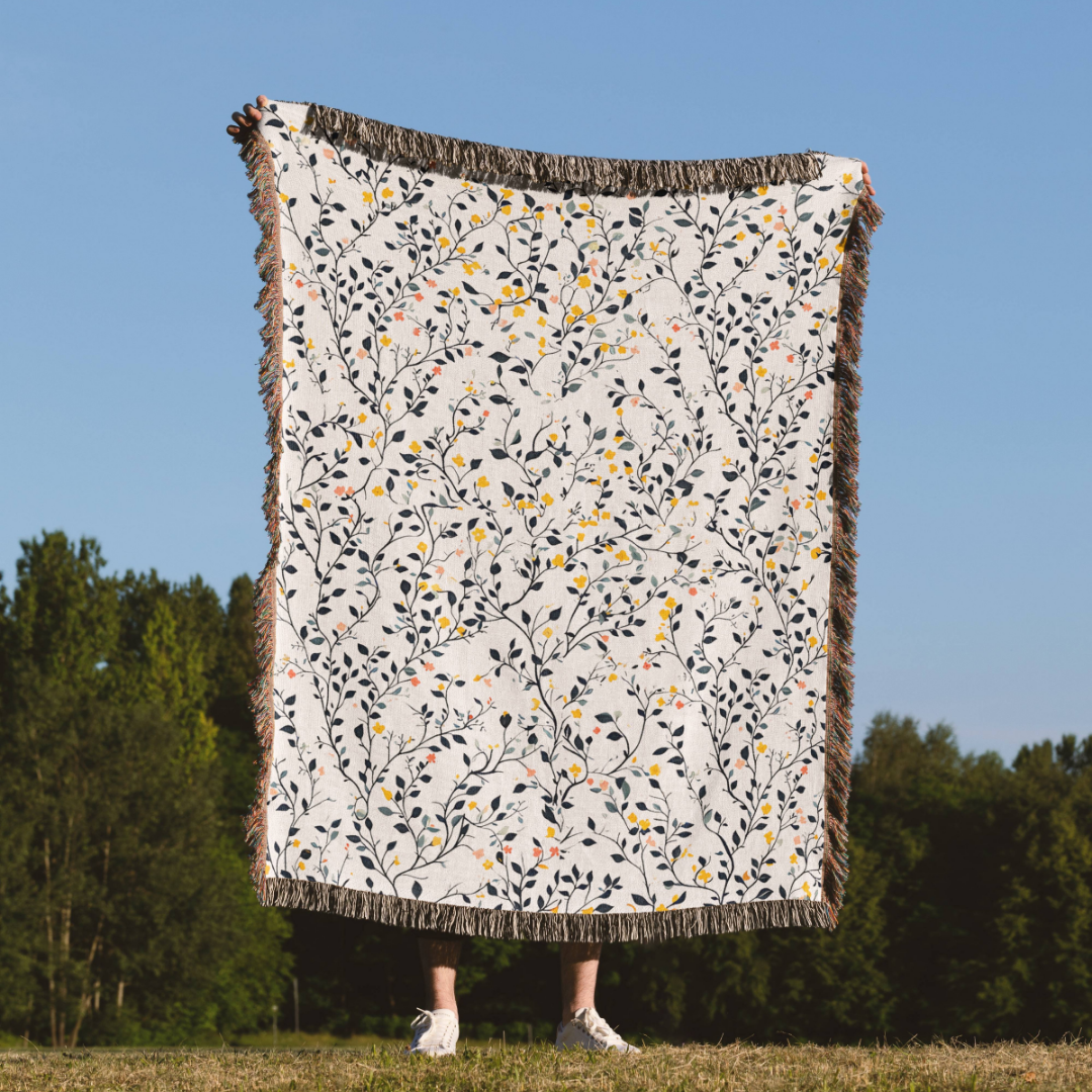 a person standing in a field holding a quilt