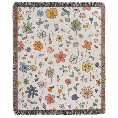 a white blanket with colorful flowers on it