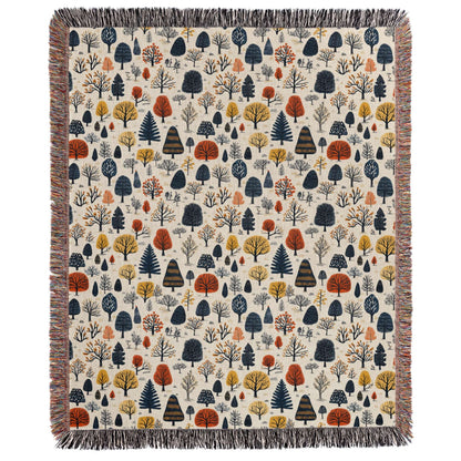 a blanket with trees and leaves on it