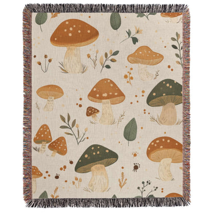 a blanket with mushrooms and leaves on it
