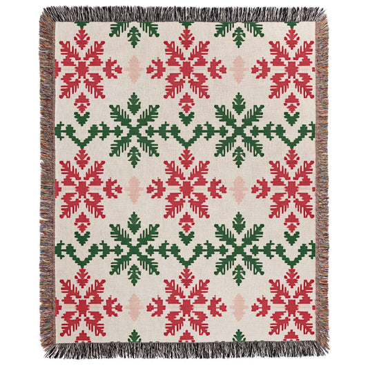 a red and green blanket with snowflakes on it