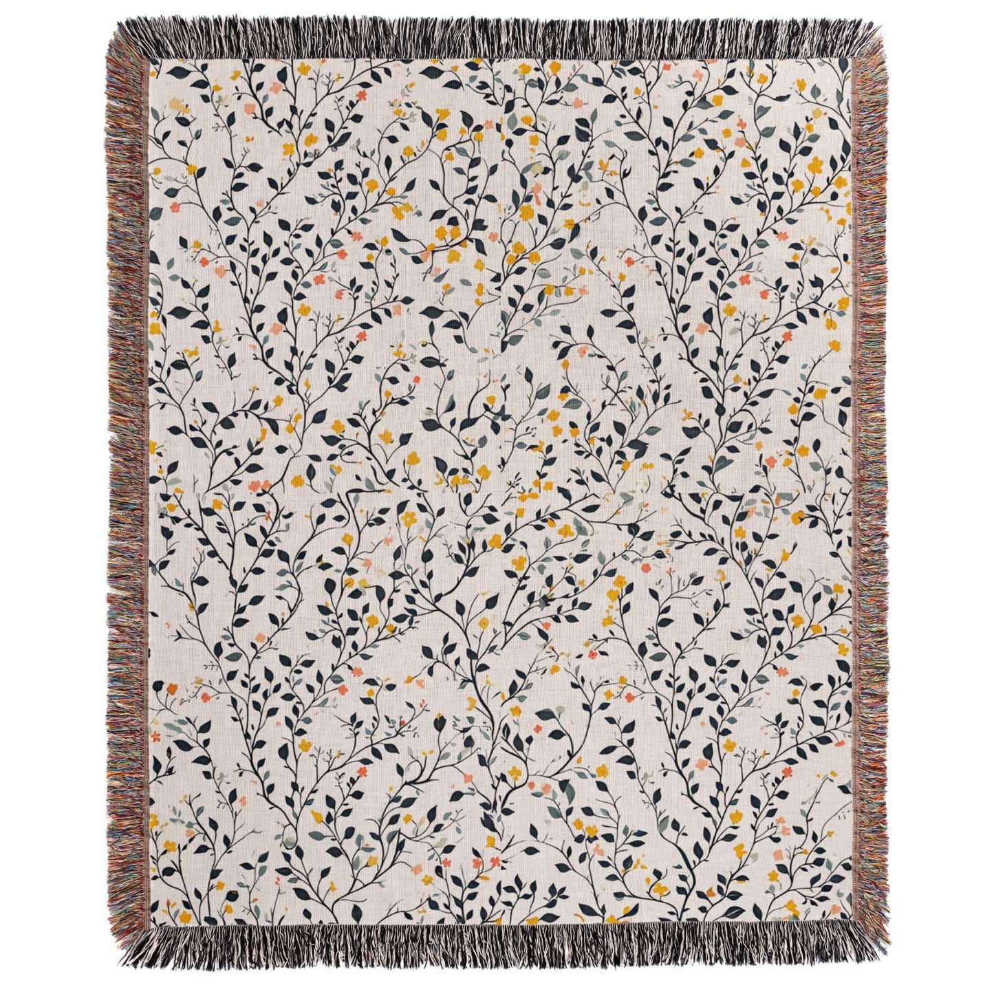 a white blanket with yellow and black flowers on it
