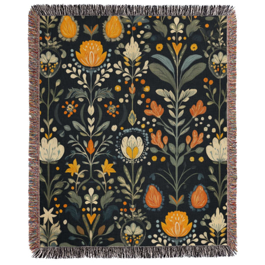 a tapestry with flowers and leaves on a black background