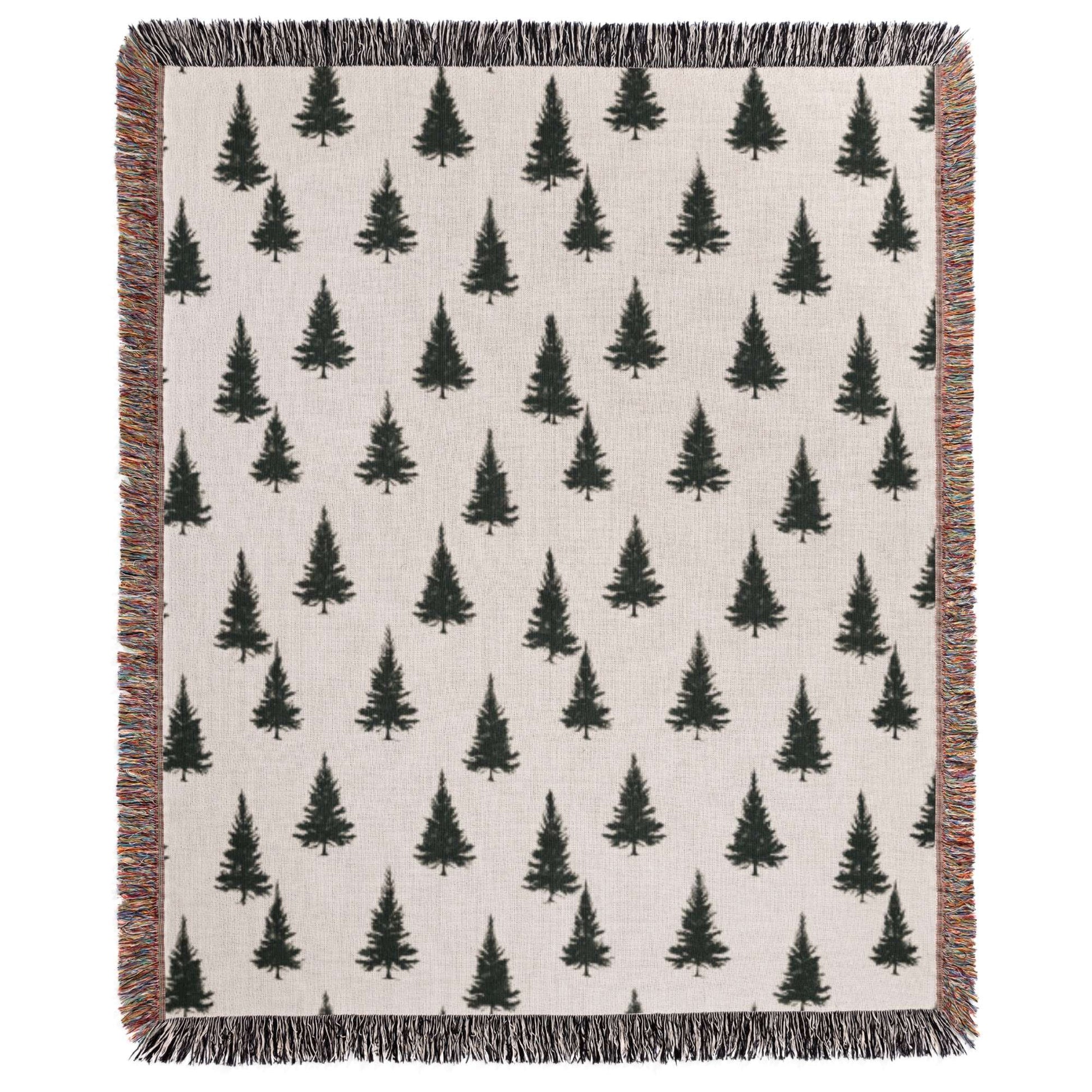 a white blanket with black trees on it