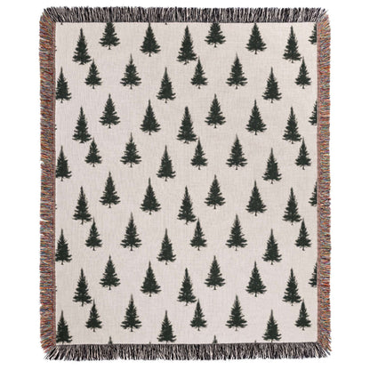 a white blanket with black trees on it
