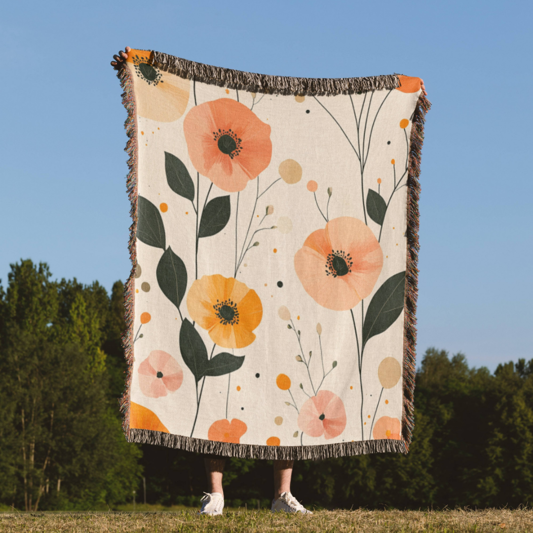 a woman standing in a field holding a blanket