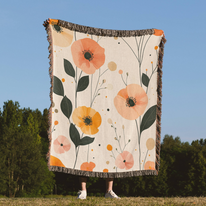 a woman standing in a field holding a blanket