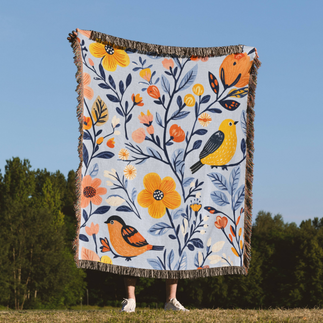 a woman standing in a field holding a blanket