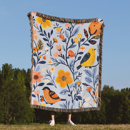 a woman standing in a field holding a blanket