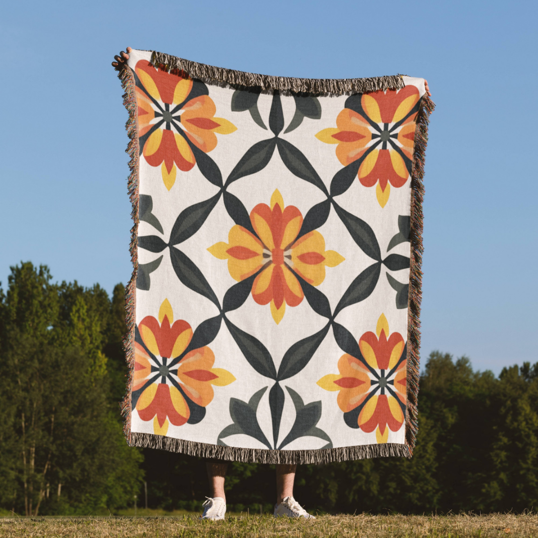 a person standing in a field holding a blanket