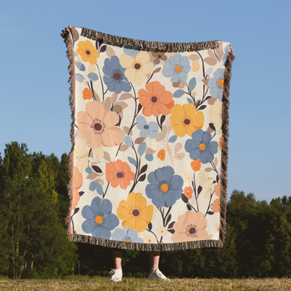 a woman standing in a field holding a blanket