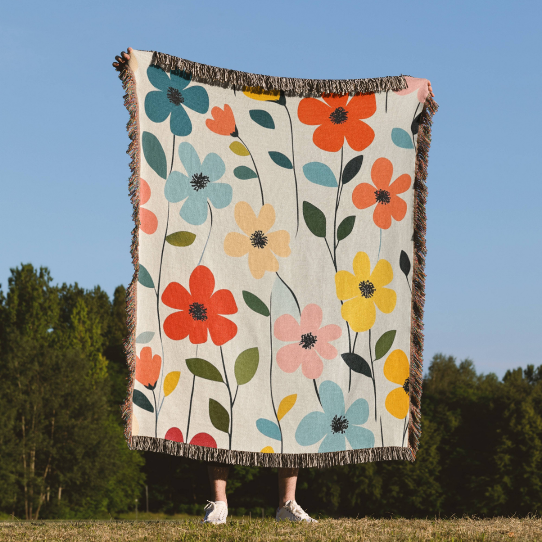 a woman is holding a blanket with flowers on it