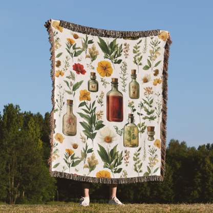a woman standing in a field holding a quilt