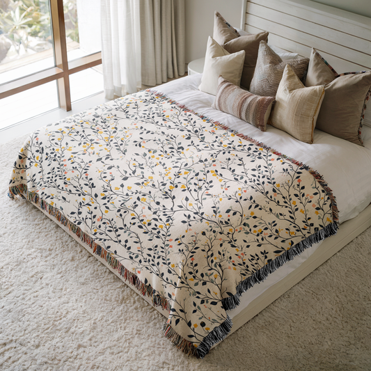 a bed with a blanket and pillows on top of it