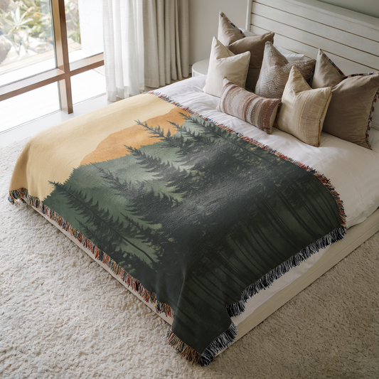 a bed with a blanket and pillows on top of it