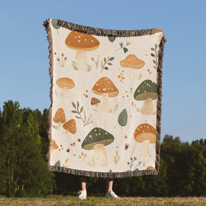 a person holding a blanket with mushrooms on it