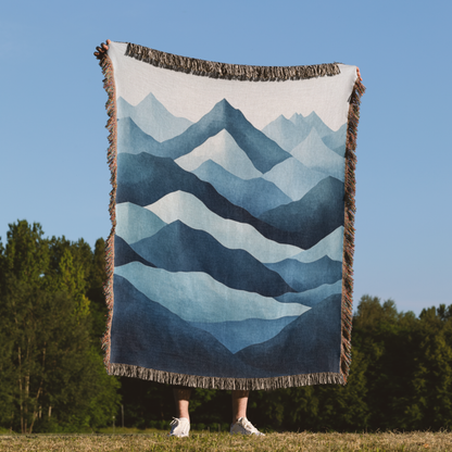 a person standing in a field holding a blanket