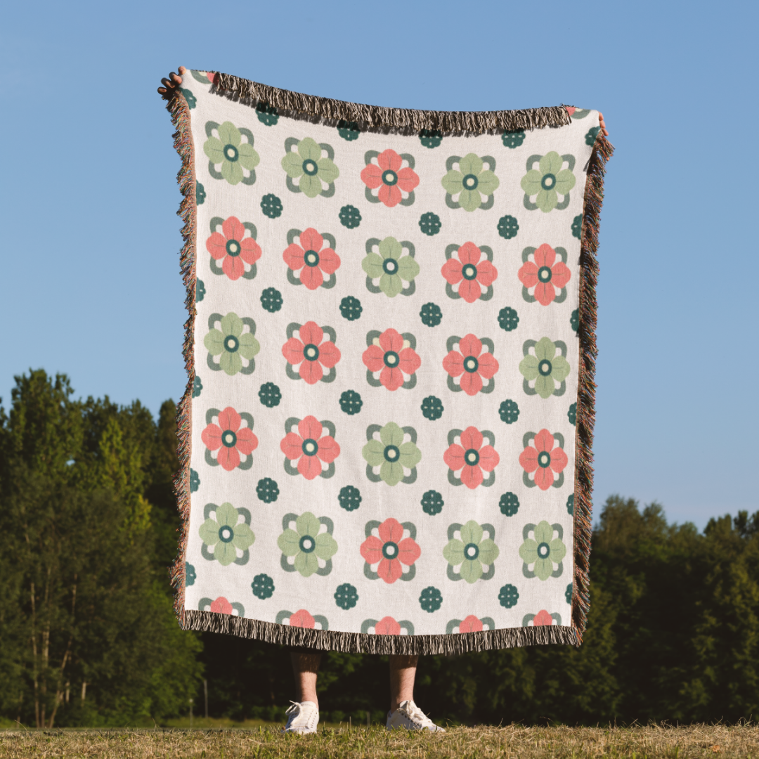 a person standing in a field holding a blanket